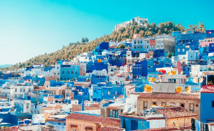blue and white painted houses on the cliff